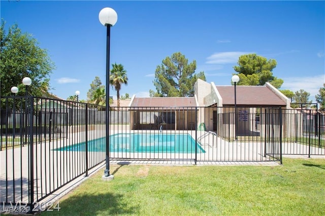 view of swimming pool featuring a patio area and a lawn