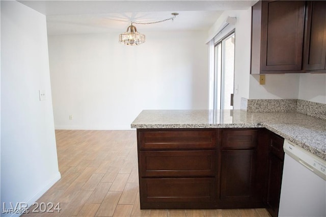 kitchen featuring light stone countertops, dishwasher, decorative light fixtures, kitchen peninsula, and a notable chandelier