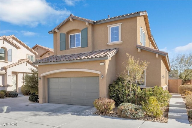 mediterranean / spanish-style house with a garage