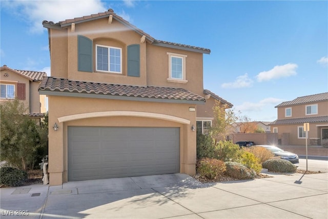 mediterranean / spanish-style house with a garage