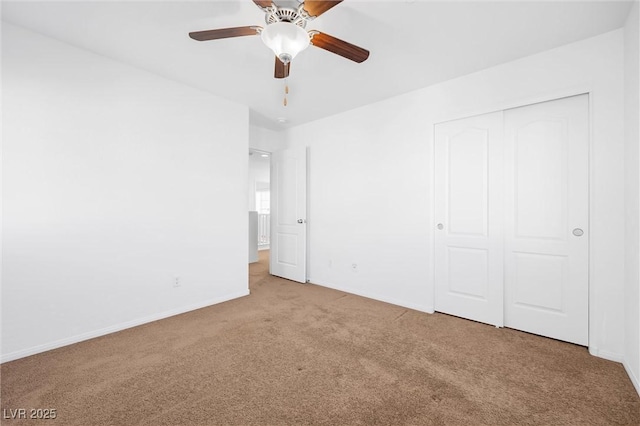 unfurnished bedroom with ceiling fan, a closet, and carpet floors