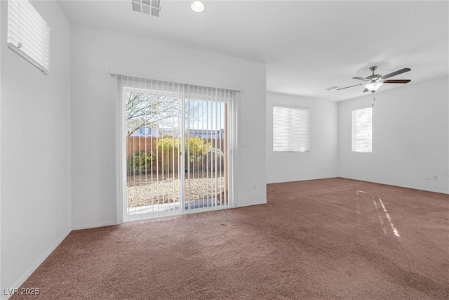 carpeted spare room with ceiling fan