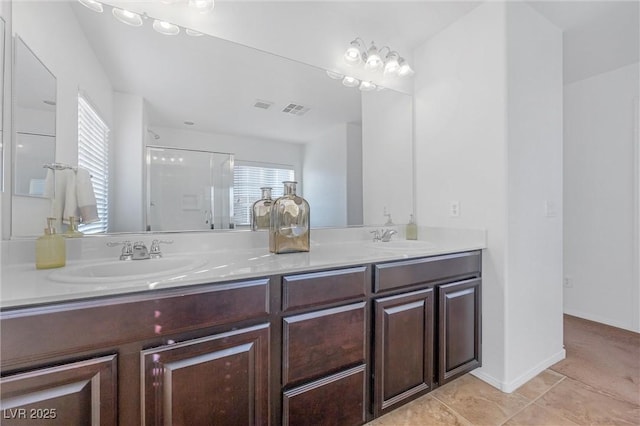 bathroom with tile patterned flooring, an enclosed shower, and vanity