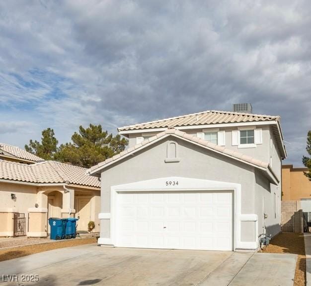 mediterranean / spanish home with a garage