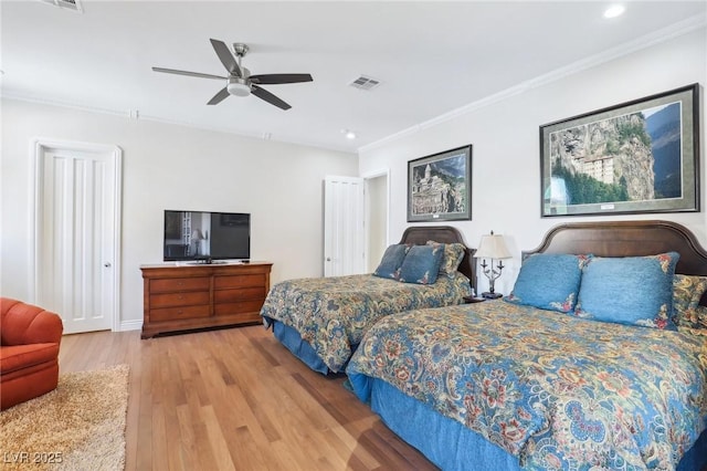 bedroom featuring ceiling fan, hardwood / wood-style flooring, and crown molding