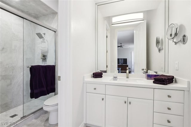 bathroom featuring toilet, a shower with door, and vanity