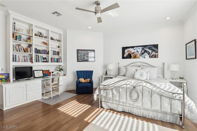 bedroom with ceiling fan, built in desk, and dark hardwood / wood-style floors