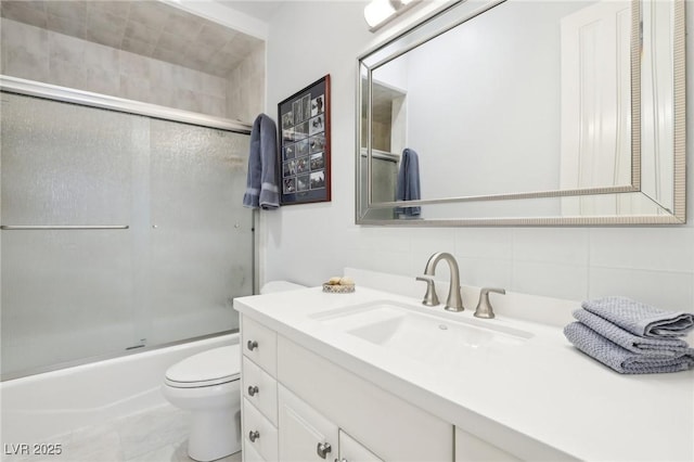 full bathroom with toilet, combined bath / shower with glass door, backsplash, and vanity