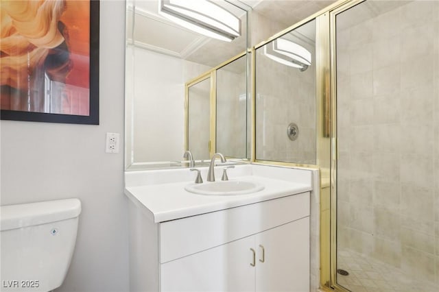 bathroom featuring toilet, a shower with door, and vanity