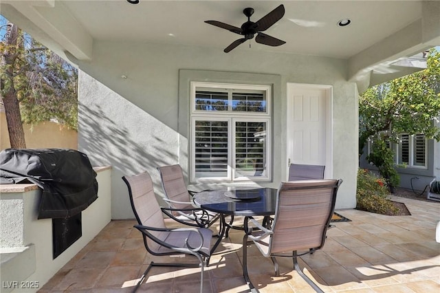 view of patio with ceiling fan and a grill