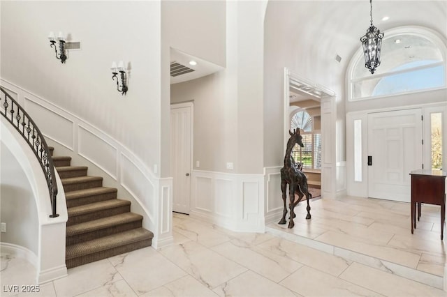 foyer with a high ceiling and ornate columns