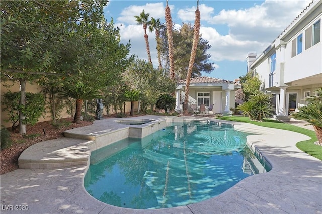 view of pool featuring a patio area and an in ground hot tub