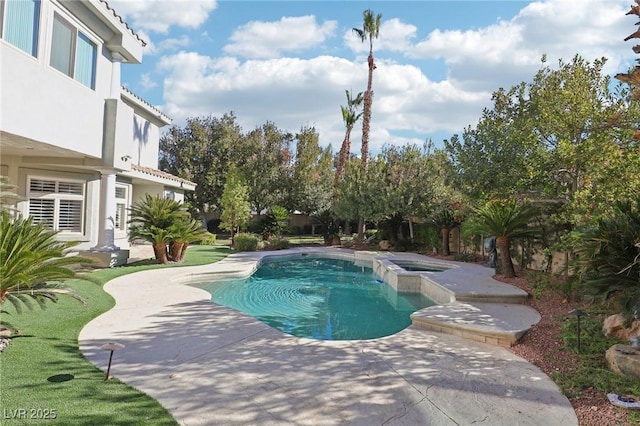 view of pool with a patio area and an in ground hot tub