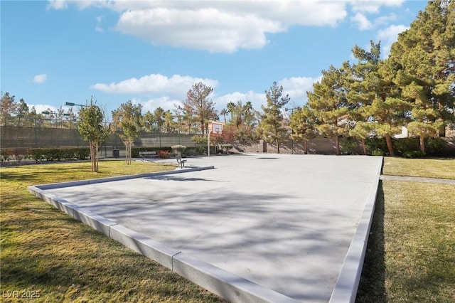 view of property's community with a lawn and basketball hoop