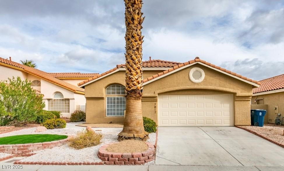 mediterranean / spanish-style home featuring a garage