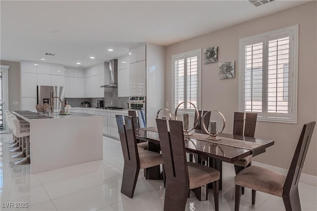 tiled dining room with sink