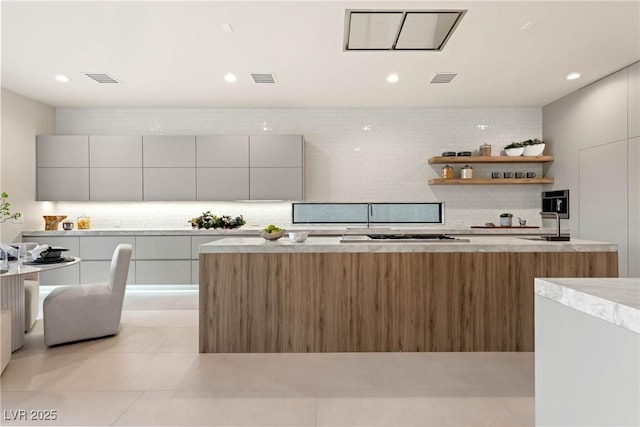 kitchen featuring white cabinets, decorative backsplash, and light tile patterned flooring