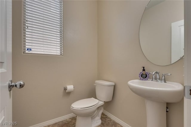 bathroom featuring sink, tile patterned floors, and toilet