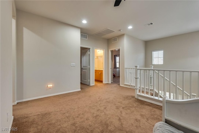 empty room with light carpet and ceiling fan