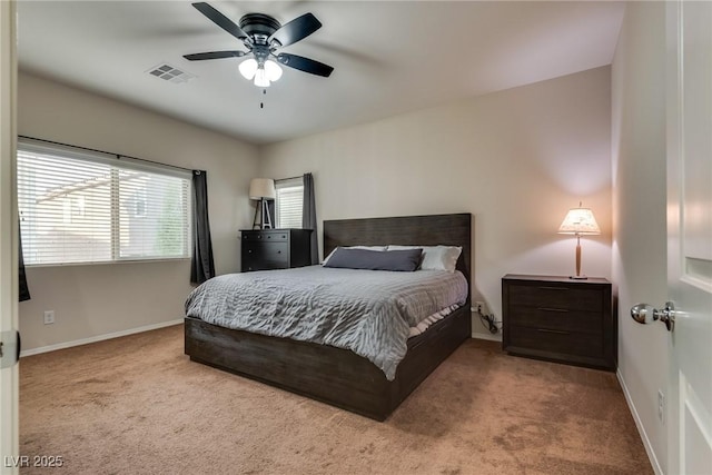 bedroom with ceiling fan and light carpet