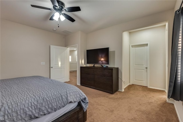 bedroom with ceiling fan and light carpet