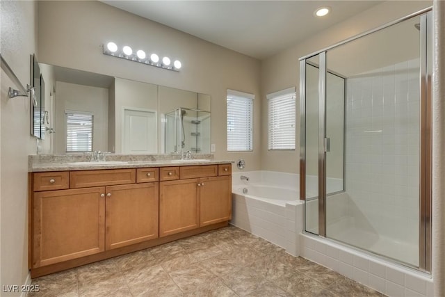 bathroom with vanity, plenty of natural light, and independent shower and bath