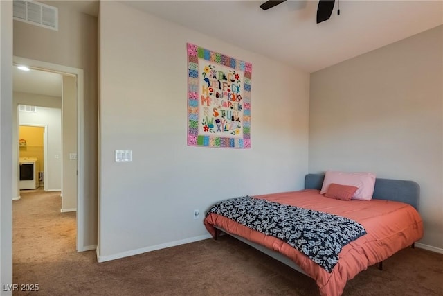 carpeted bedroom featuring ceiling fan and washer / dryer