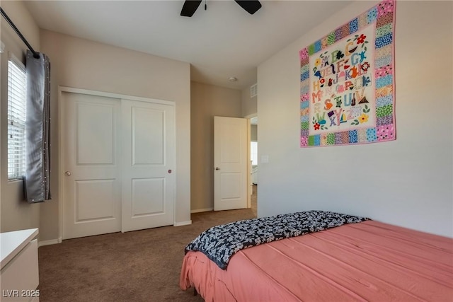 carpeted bedroom featuring ceiling fan and a closet