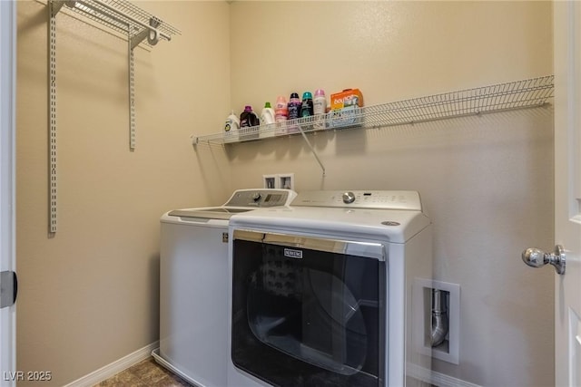 clothes washing area with washing machine and clothes dryer