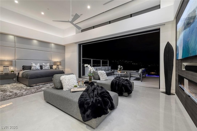 bedroom featuring ceiling fan and a towering ceiling