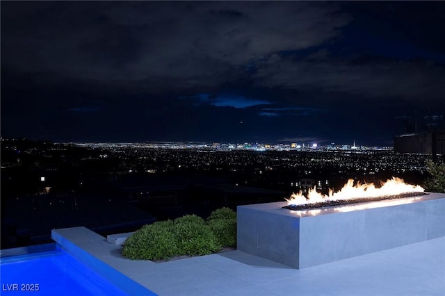 view of swimming pool with a fire pit