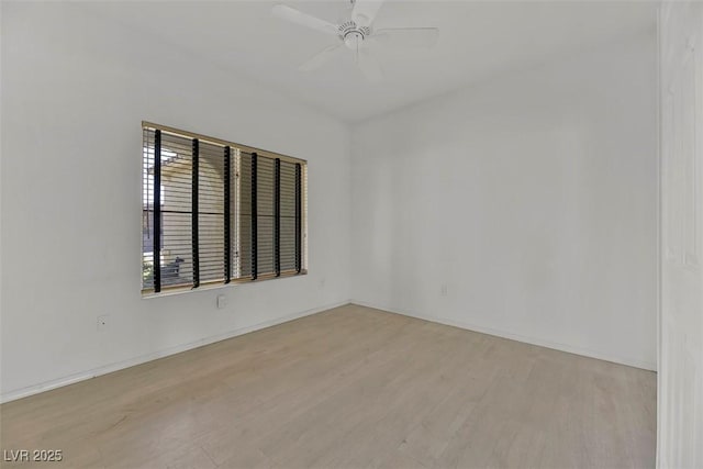 spare room with ceiling fan and light wood-type flooring