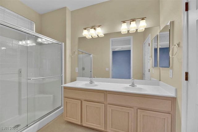 bathroom featuring vanity and a shower with shower door