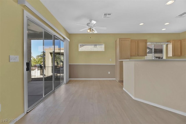 kitchen featuring ceiling fan, light wood-type flooring, and light brown cabinetry