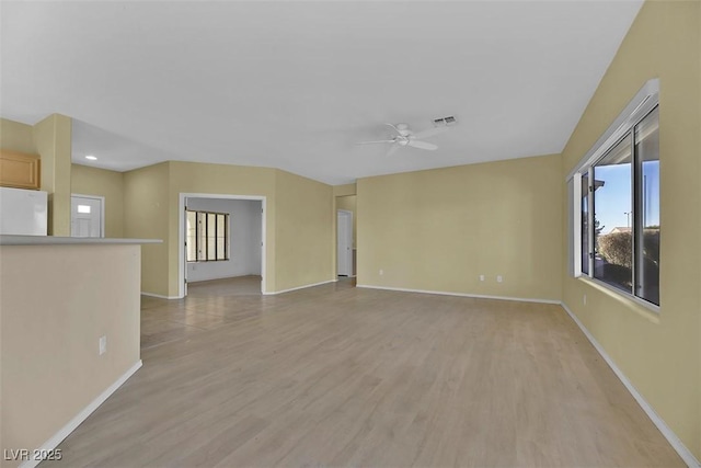 unfurnished room with ceiling fan and light hardwood / wood-style floors