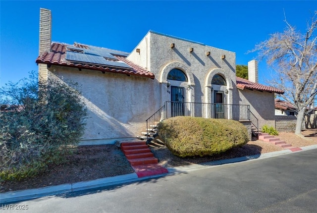 view of front of home with solar panels