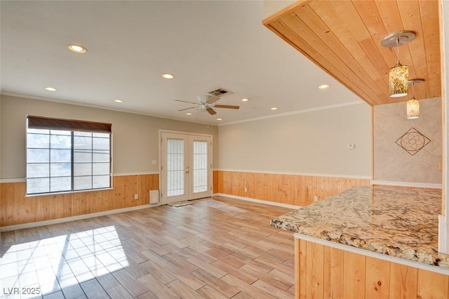 kitchen with pendant lighting, light hardwood / wood-style flooring, ornamental molding, and french doors