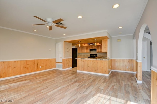 kitchen featuring ornamental molding, kitchen peninsula, stove, and light hardwood / wood-style flooring