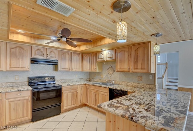 kitchen featuring black appliances, light brown cabinetry, sink, and hanging light fixtures