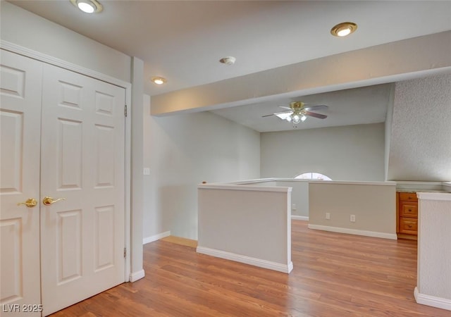 interior space with light hardwood / wood-style floors and ceiling fan