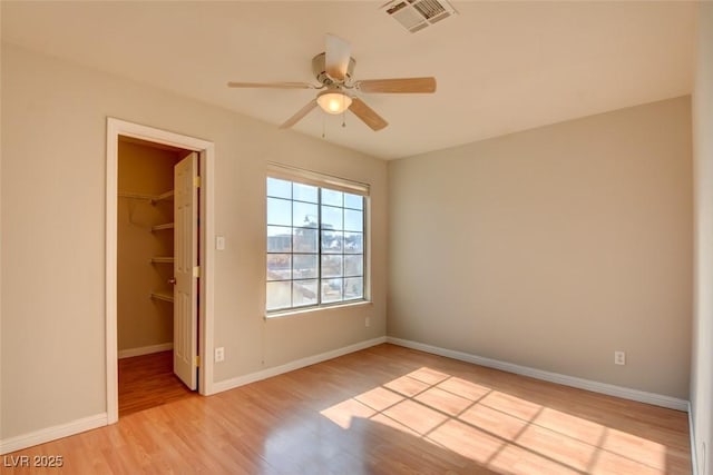 unfurnished room featuring ceiling fan and light wood-type flooring