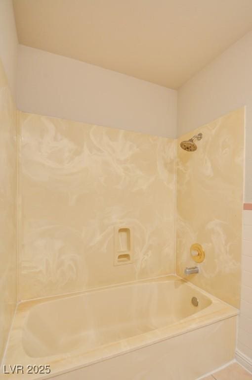 bathroom featuring tiled shower / bath combo and tile patterned floors