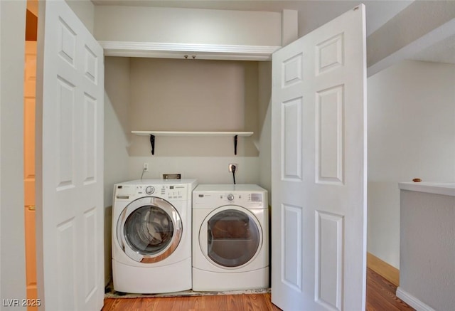 laundry room with light hardwood / wood-style flooring and independent washer and dryer