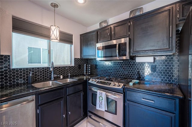 kitchen with appliances with stainless steel finishes, tasteful backsplash, sink, decorative light fixtures, and a healthy amount of sunlight