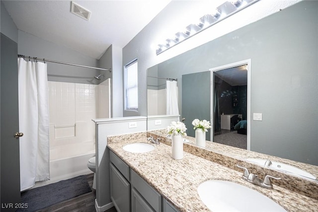 full bathroom featuring vaulted ceiling, wood-type flooring, vanity, toilet, and shower / tub combo with curtain