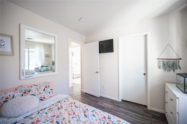 bedroom featuring dark hardwood / wood-style flooring