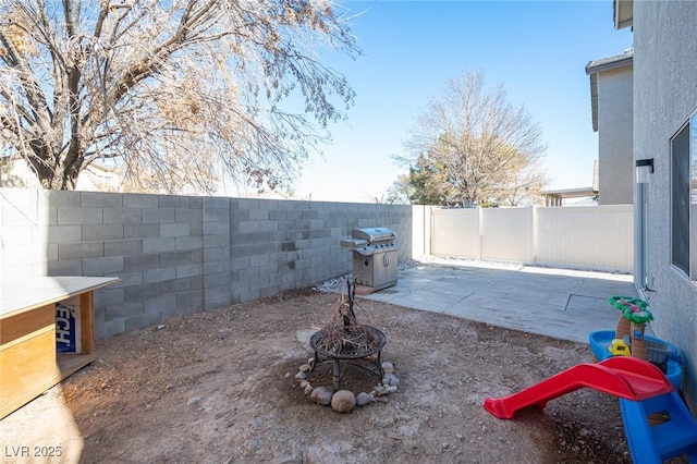 view of patio / terrace featuring a fire pit and a grill