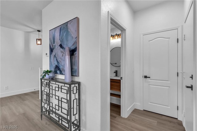 corridor with hardwood / wood-style flooring