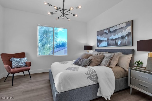 bedroom featuring hardwood / wood-style flooring and a notable chandelier