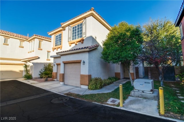 mediterranean / spanish-style house with a garage